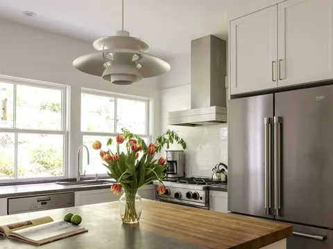 Bright white kitchen with a butcher-block island
