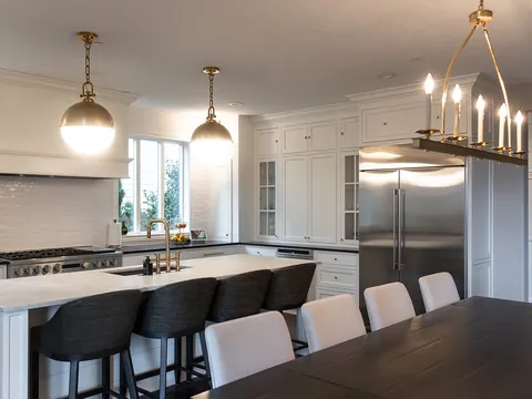 White kitchen with brass pendants